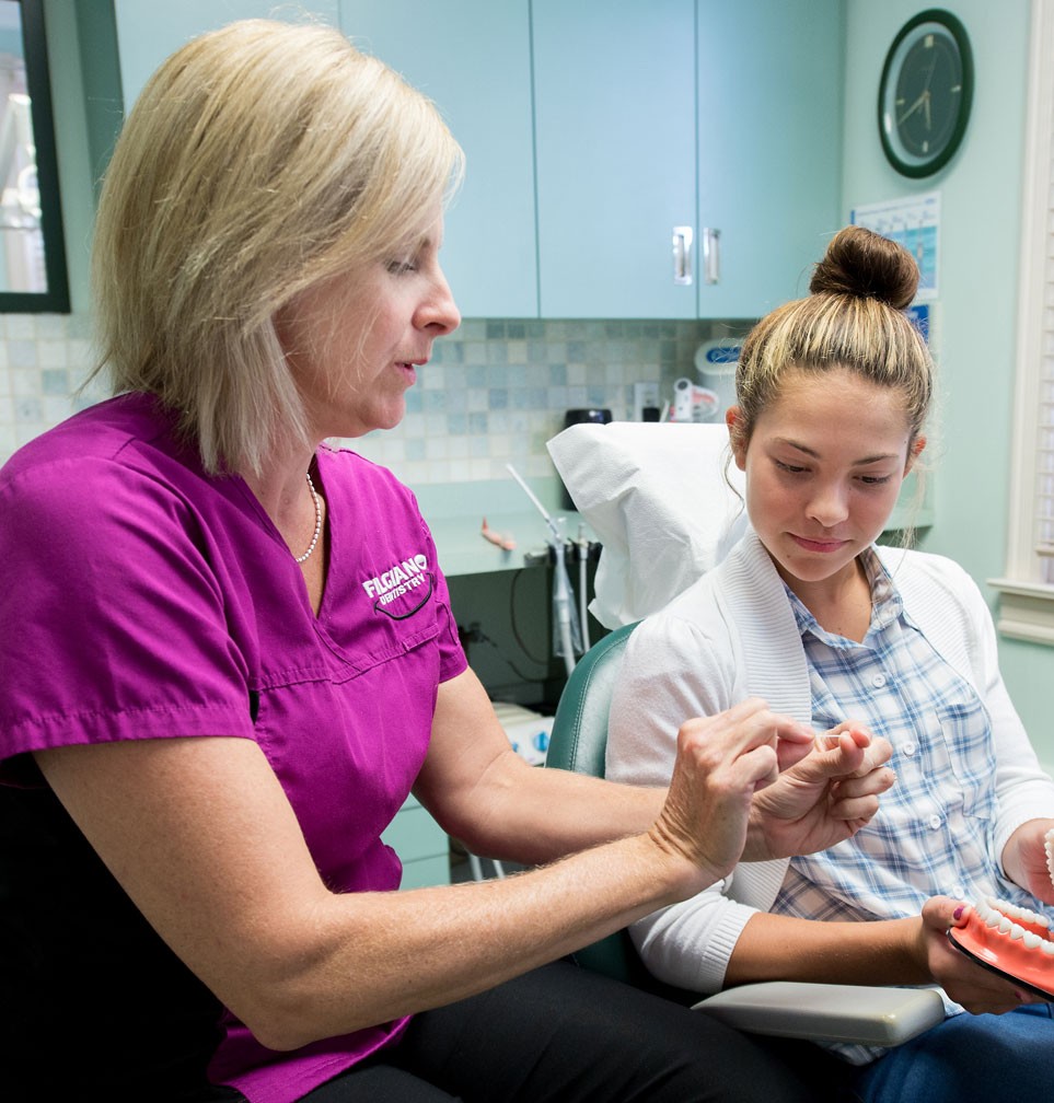 dental hygenist with young patient