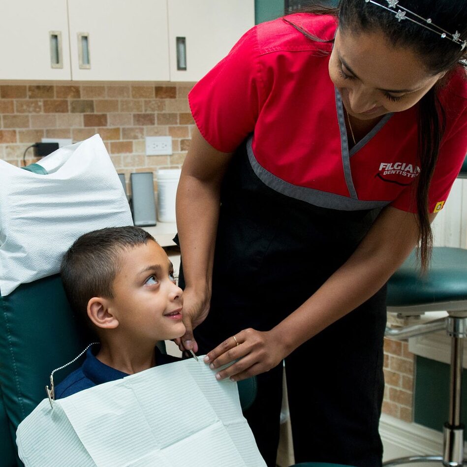 dentist assistance comforting young patient